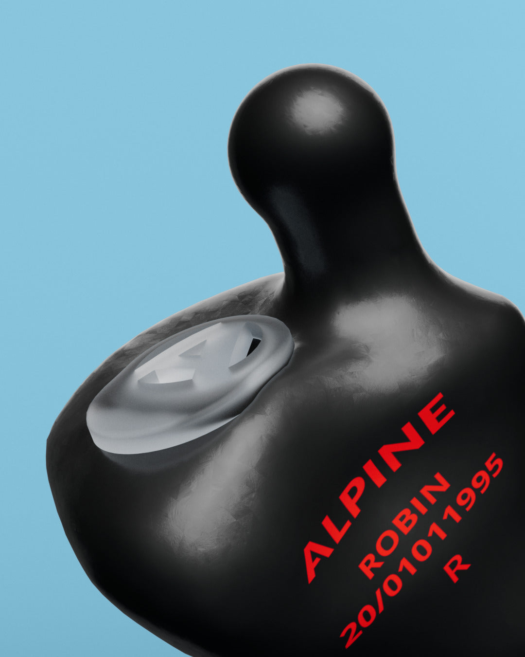 Close-up of an Alpine MusicSafe Custom Black earplug with filter and the engraving &