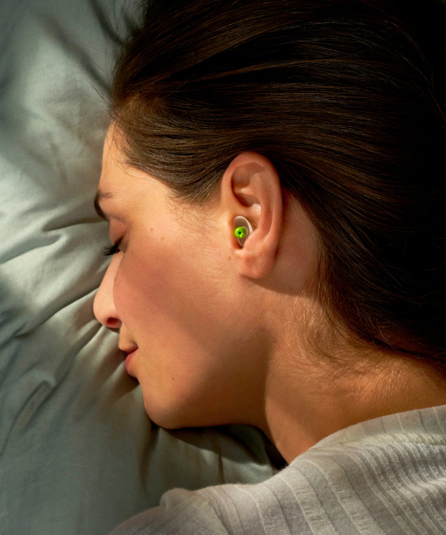 Woman sleeping while wearing Alpine Sleepsoft