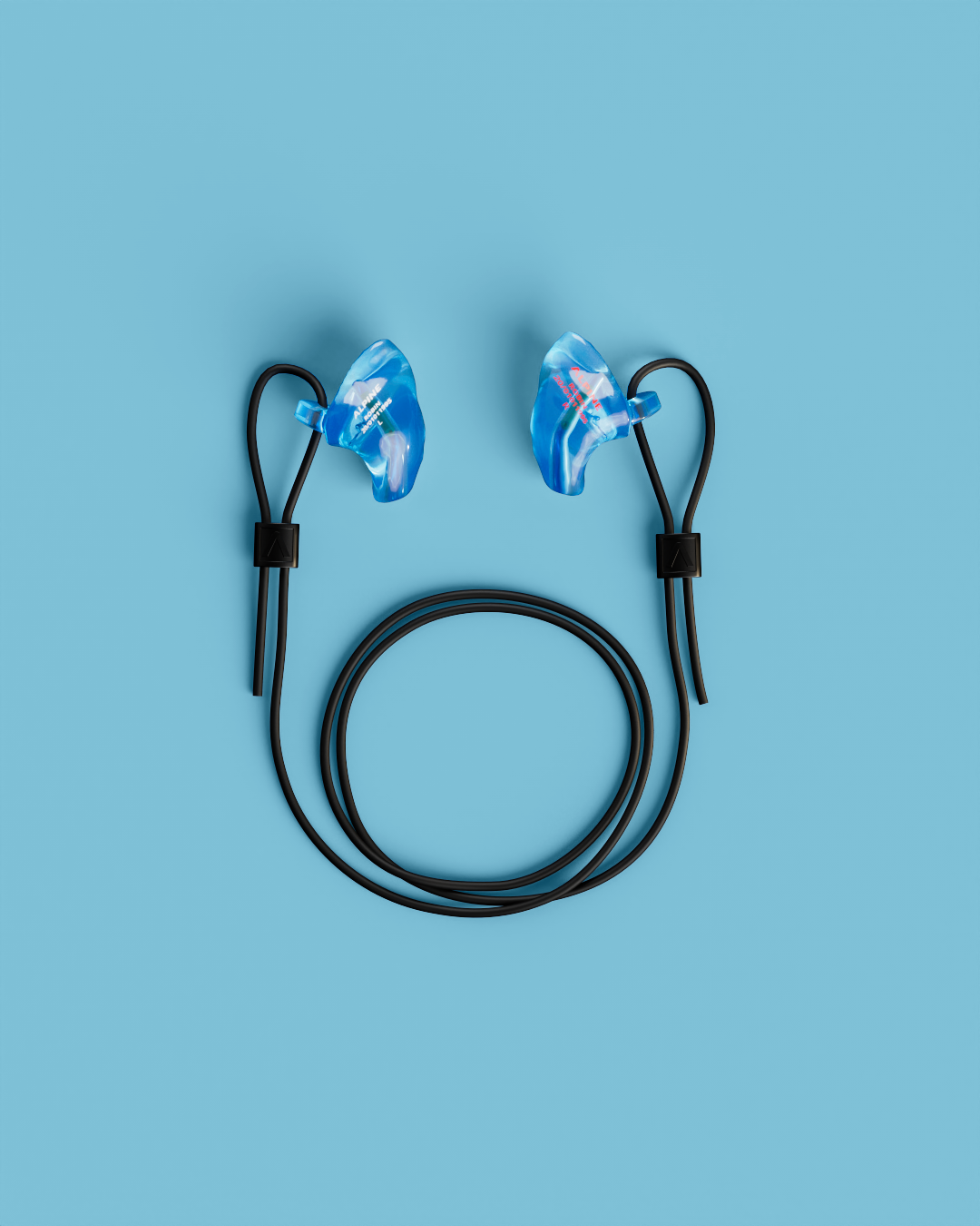 Pair of Alpine WorkSafe Custom Transparent Blue earplugs with a coiled black cord, seen from above 