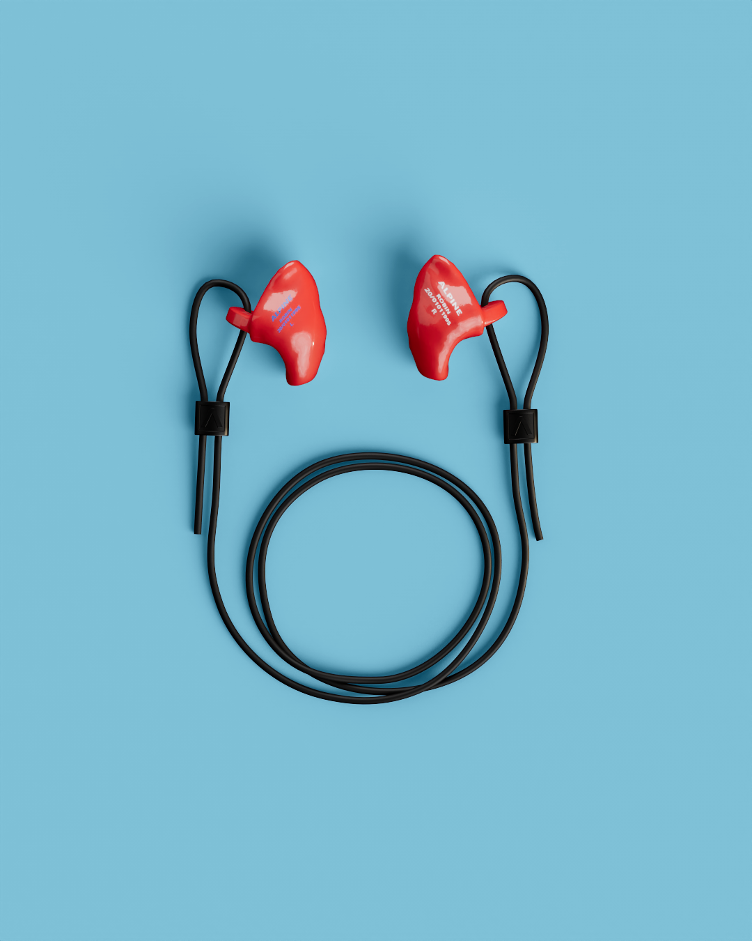 Pair of Alpine WorkSafe Custom Red earplugs with a coiled black cord, seen from above 