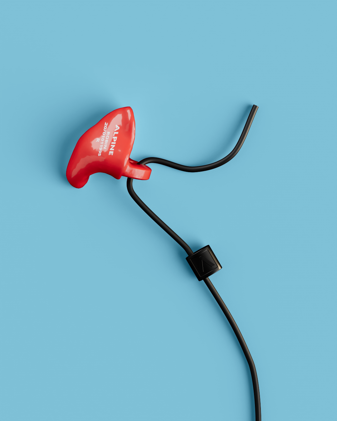 Close-up of a single Alpine WorkSafe Custom Red earplug attached to a black cord 