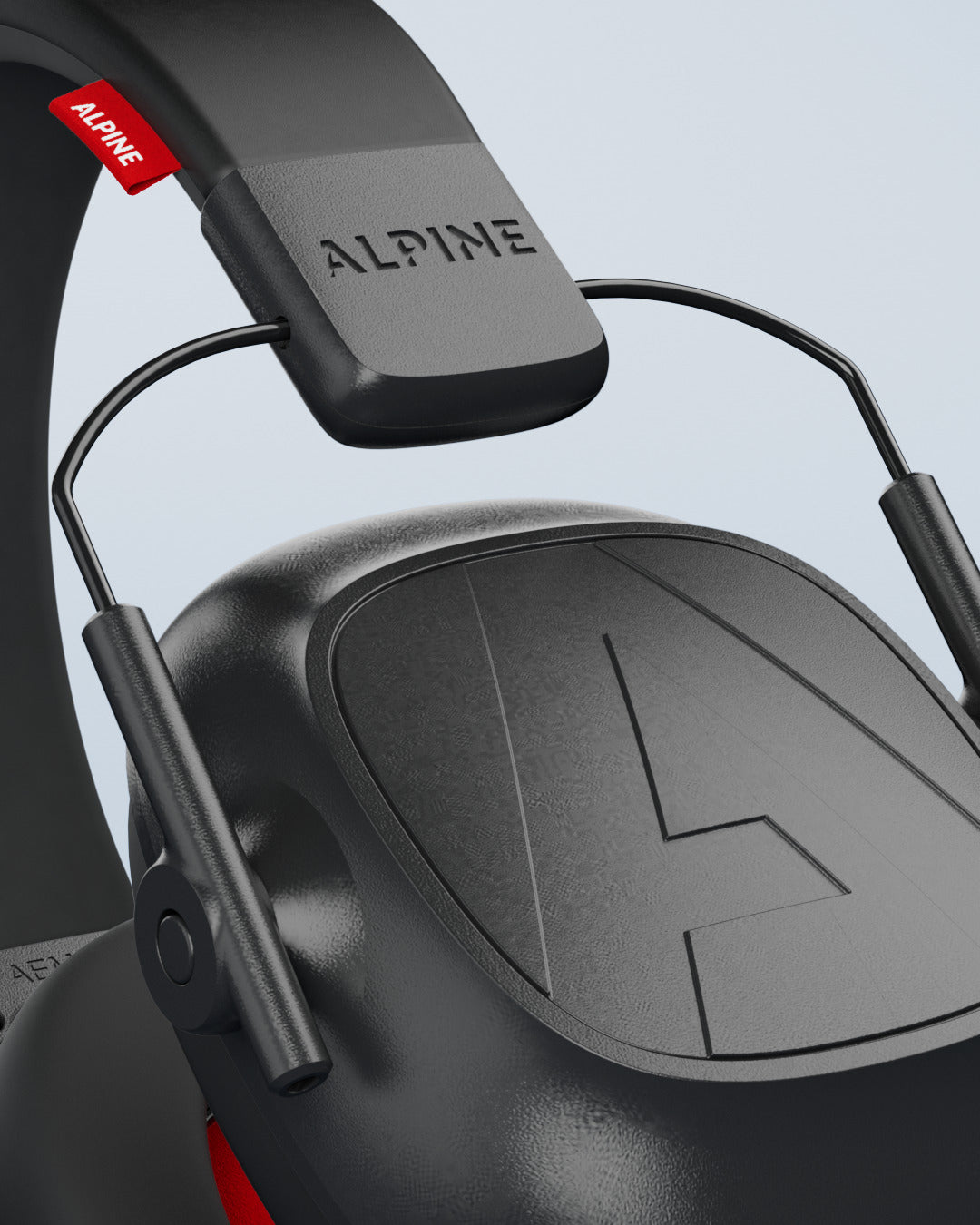 Close-up of the Alpine Defender headband with the Alpine logo and an ear cup 
